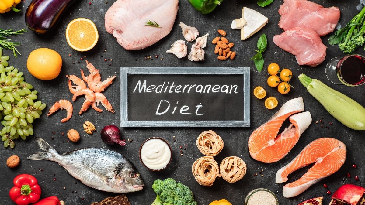 A photo of Mediterranean food choices with a cardboard saying “Mediterranean Diet” in the middle