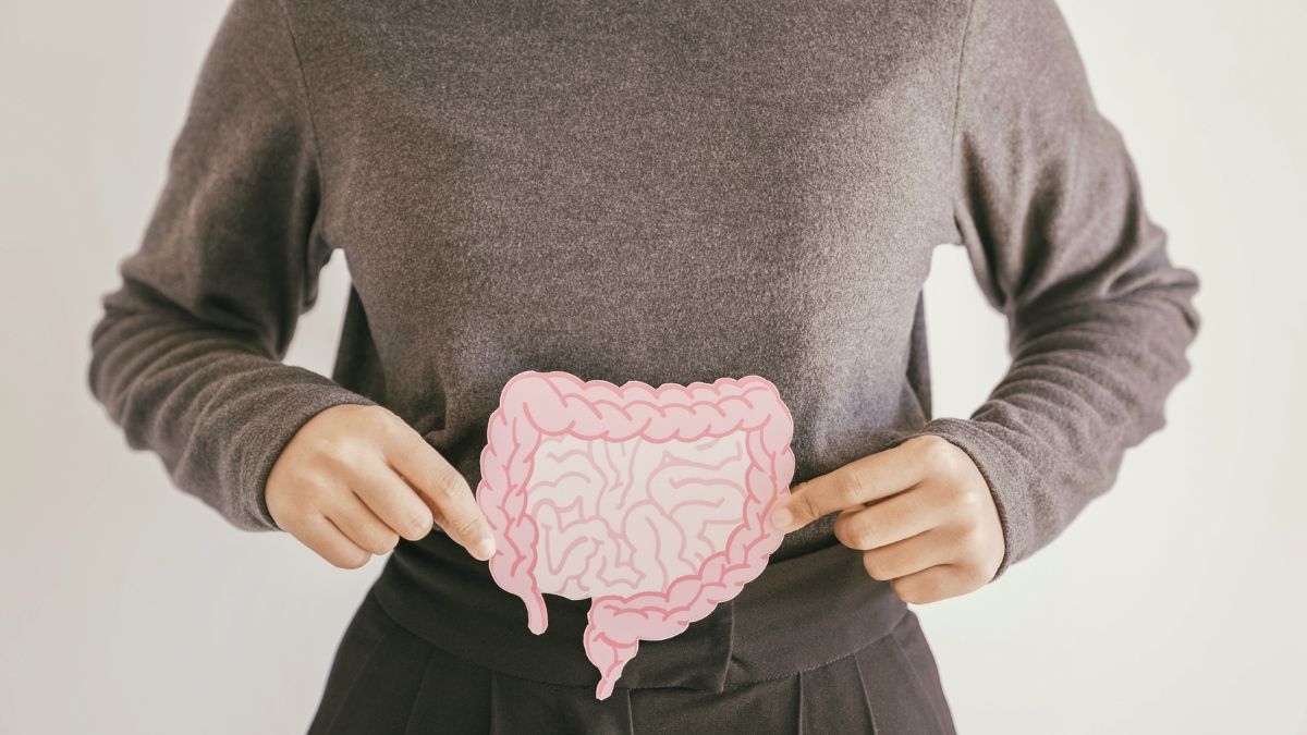 A woman holding a graphic photo of the intestine