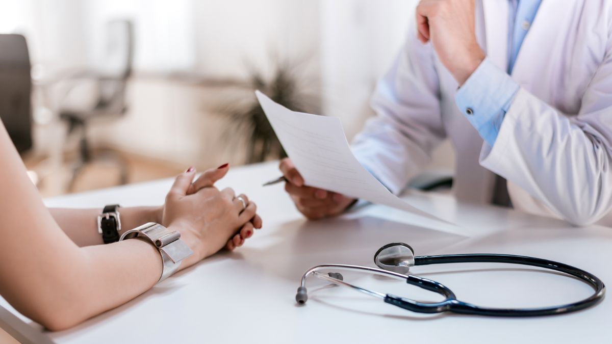 A photo of a patient talking to a doctor