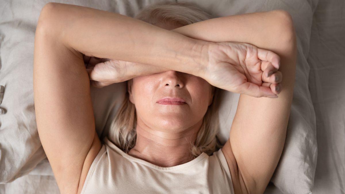 A photo of a woman struggling to sleep