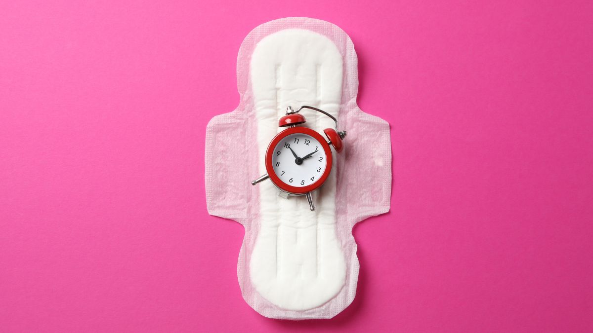 A photo of a menstruation pad with a clock on top of it