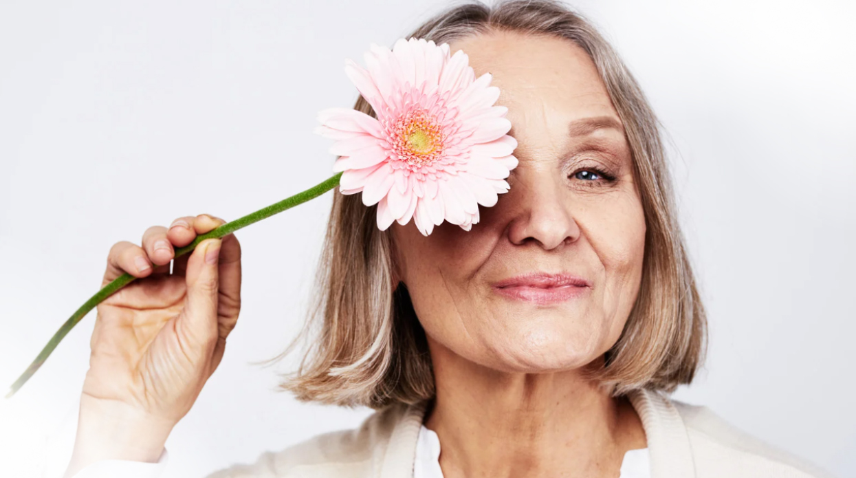 You are whole, even when things feel unfamiliar. Older women holding flower